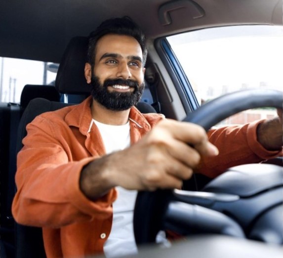 Man behind steering wheel of car stock image